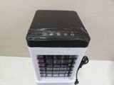 a small black and white air conditioner on a table