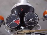 two gauges on the handlebars of a motorcycle