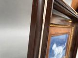 a picture of a horse in a frame on the wall