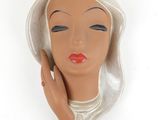 une image représentant une tête de mannequin coiffée d'un chapeau