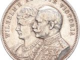 une vieille pièce d'argent sur laquelle figurent les portraits d'un homme et d'une femme