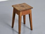 a small wooden stool sitting on the floor in a room