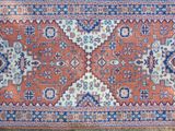 a close up of a rug on a wooden floor in a room