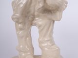 a white statue of a man with a bag on his back