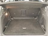 a trunk of a car with the back door open