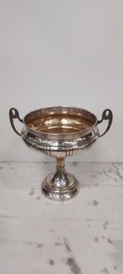 a silver plate with a handle on it on a table