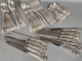 a lot of silver spoons and forks on the table