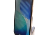 an image of a cell phone on a stand on a white surface