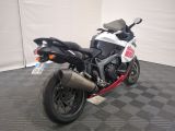 a motorcycle that is parked on the floor in a garage