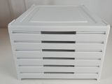 a stack of four white boxes on a table