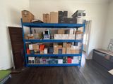 a blue shelving with many boxes on it in a room