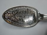 a silver spoon with a floral design on it