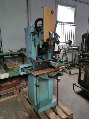 a machine that is sitting in a room with many pieces of wood