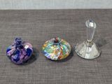 trois petits objets en verre posés sur une table