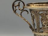 a silver cup with a lion on it sitting on a table