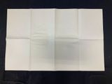 an image of a folded piece of white paper on a black surface