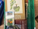 a green box filled with books and other items on a table