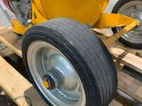 a small yellow machine on a wooden pallet