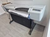 a large printer sitting on a stand in the corner of a room