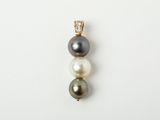 a black and white pearl and diamond pendant on a white background