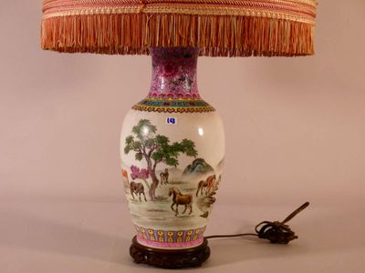 a lamp that is sitting on a table with a lamp shade on it