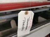 a red and white surfboard hanging on the back of a bus