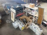 many containers of water sitting on the floor next to a cart