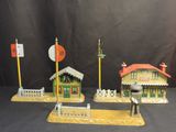 three toy buildings that are sitting on a table
