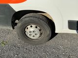 an orange and white bus parked on the side of the road