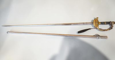 two swords that are laying next to each other on a table