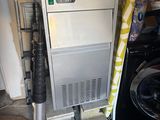 a machine that is sitting on top of a washing machine