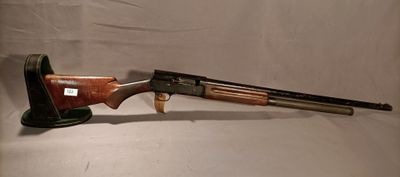 a rifle with a wooden barrel and a wooden handle on a white background