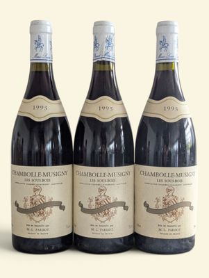 three bottles of wine sitting on top of a table next to each other