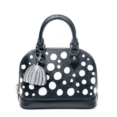 black and white polka dotty handbag with a pom pom