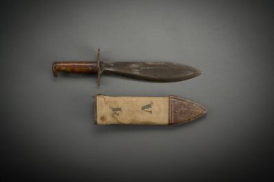 pair of knifes on a gray surface with a black background