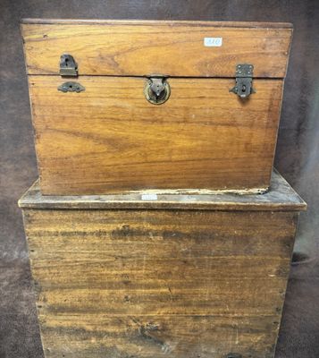 an old wooden chest with two metal handles and a wooden box on top of it
