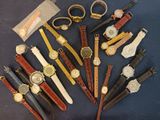 many different types of watches on a blue surface
