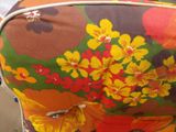 a suitcase with a flower pattern on it sitting on a table