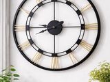 une image représentant une grande horloge noire et dorée accrochée au mur