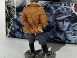 a figurine of a man standing in front of a box