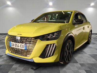 a yellow car parked in a garage with a checkered floor
