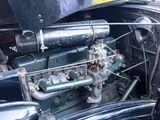 a close up of an old car engine with the hood up