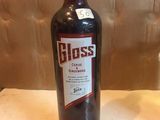 a bottle of wine sitting on a table next to a glass of wine