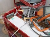 a red cart with a lot of tools on top of it