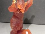 a figurine of a man holding a piece of bacon