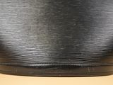 a close up of a black purse on a table