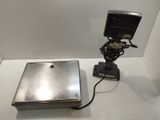 a laptop sitting on a table with a light on it