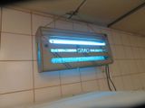a neon sign hanging on the wall of a bathroom