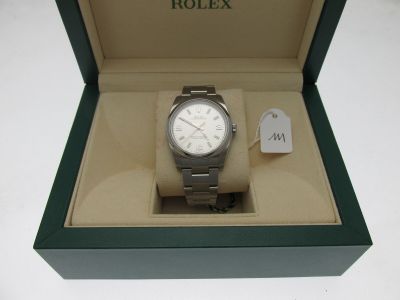 a rolex watch in a box on a table
