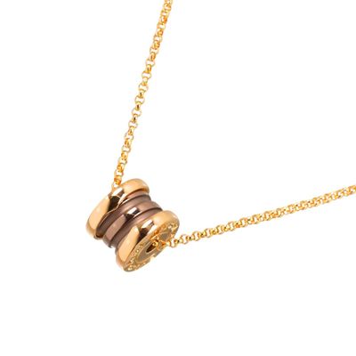 the necklace is made of gold and brown stones on a gold chain